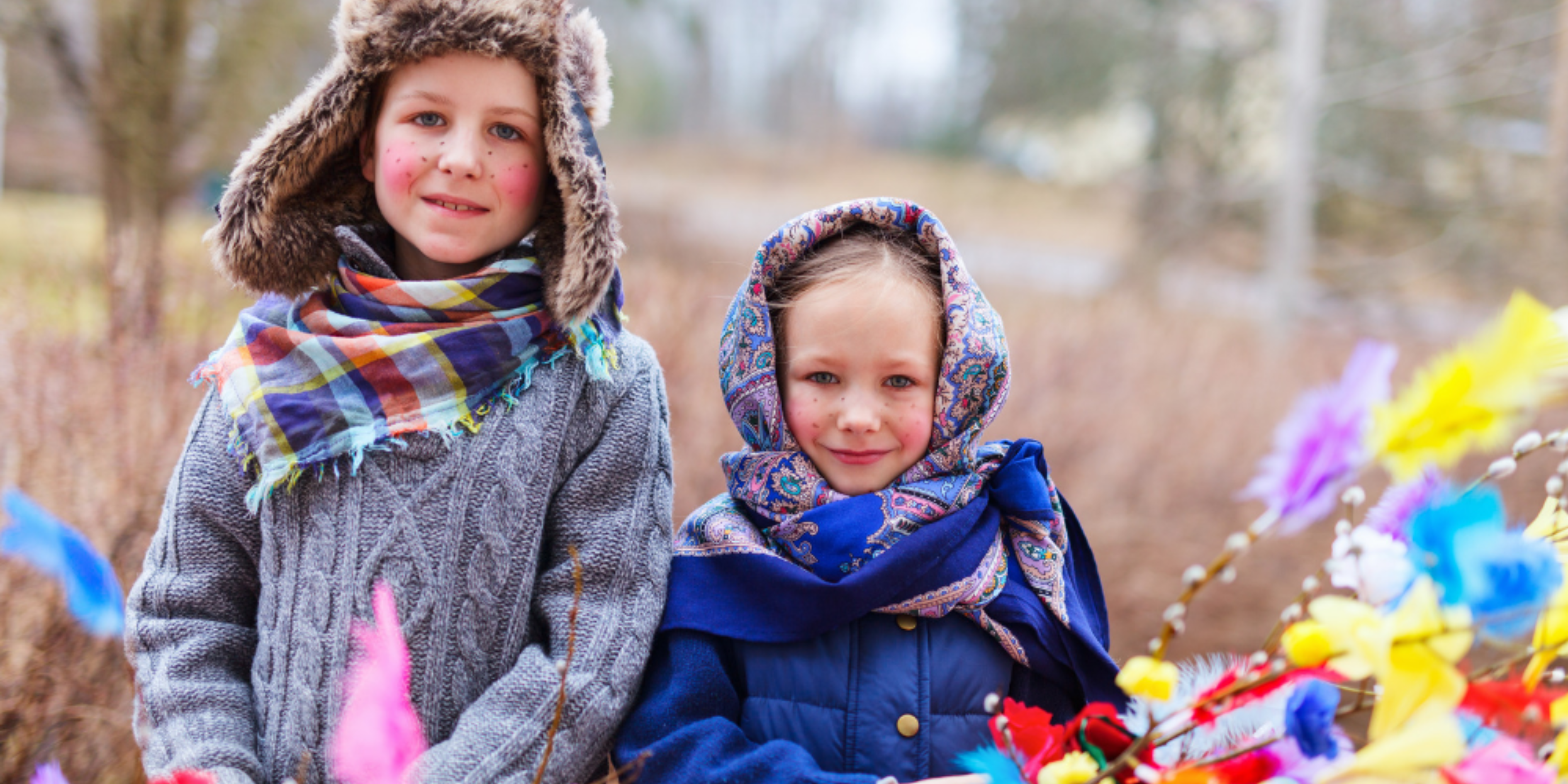 5 Easter Celebrations Around the Globe: Embracing Diversity and Tradition This is an image of two children dressed in colourful costumes as 'trulli witches', with painted freckles on their faces.