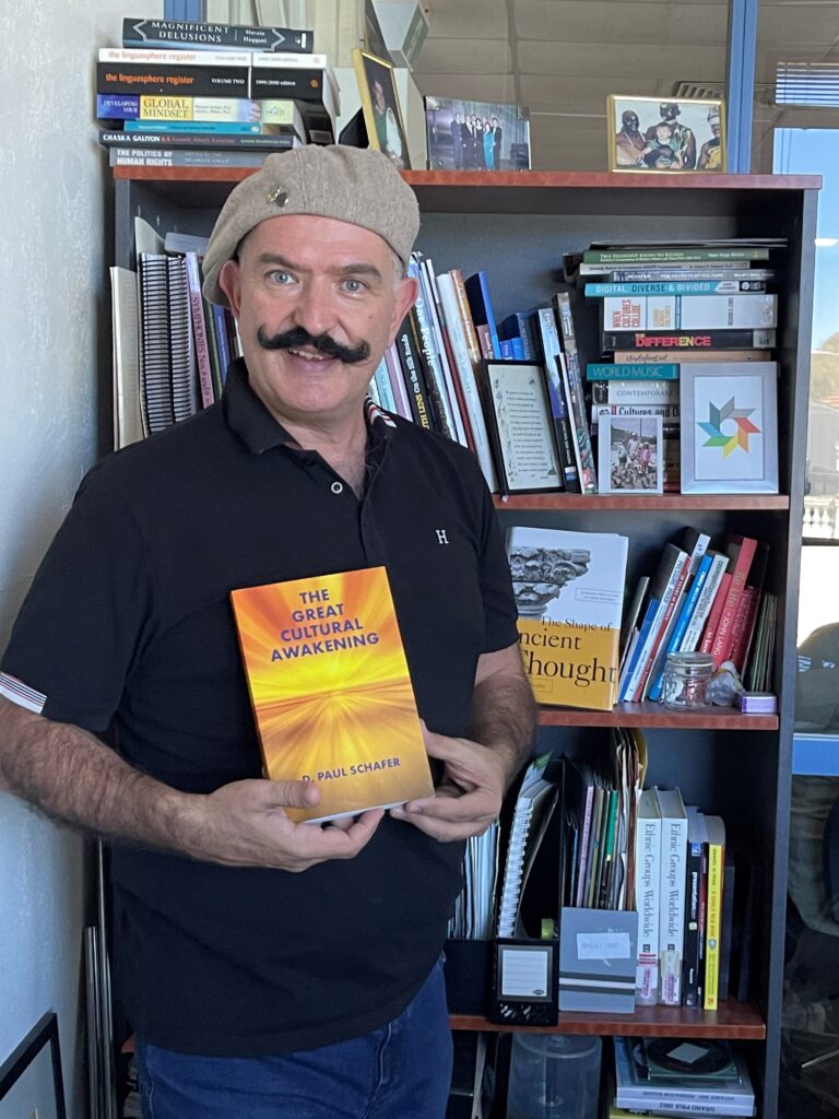 Peter Mousaferiadis holding copy of The Great Cultural Awakening