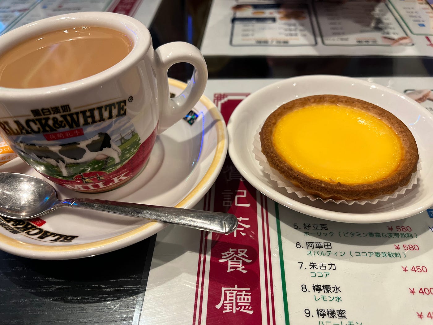 A typical afternoon tea in Hong Kong: warm drink and an egg tart